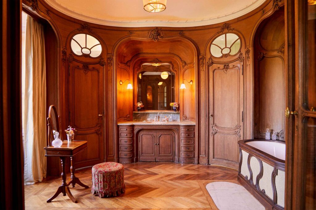 A room with detailed wooden walls and furniture at Abbaye des Vaux-de-Cernay.