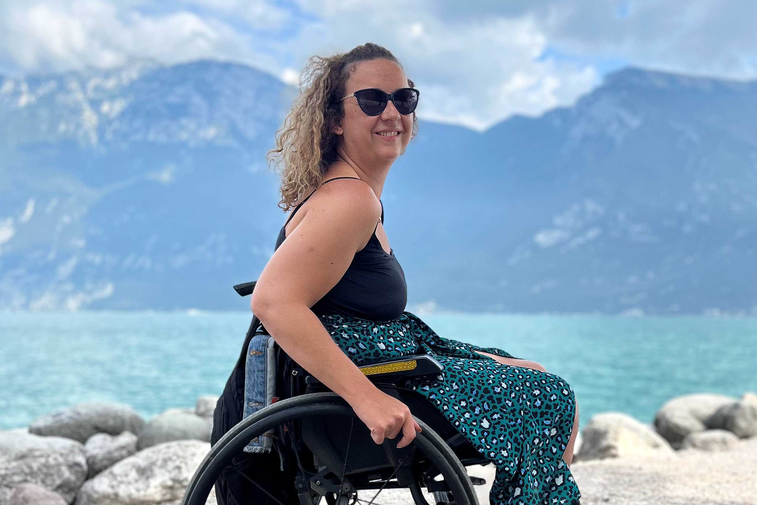 Carrie-Ann Lightley poses for a picture in front of a lake in Italy