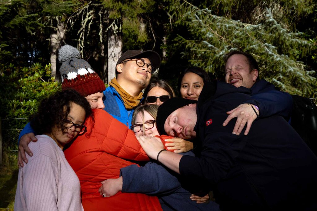 Travellers with different cognitive abilities hug their travel companions on a trip with Go Beyond Holidays, founded by Ian Callen