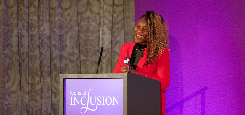 Aisha Shaibu-Lenoir speaking from a lectern at Icons of Inclusion 2024