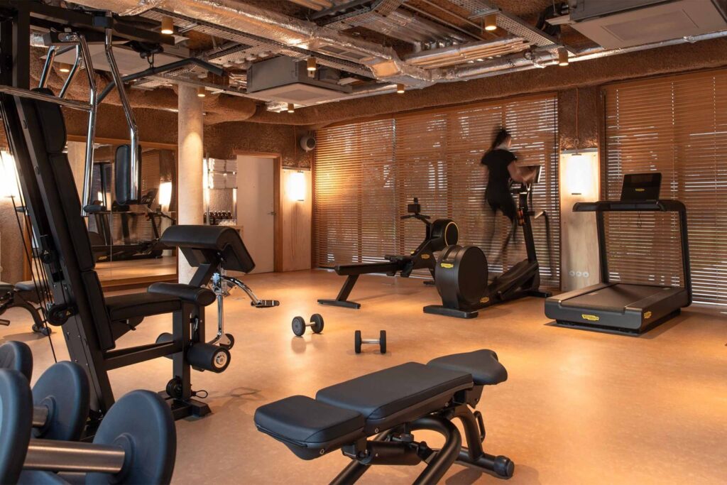 A gym space at Mob House with a guest on a running machine.