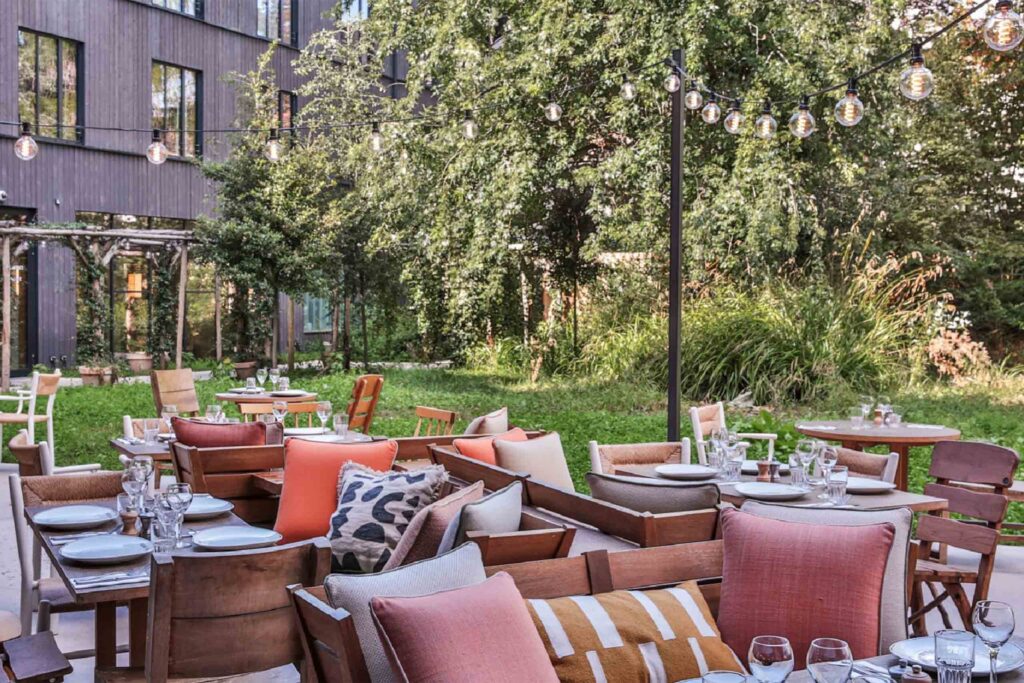 An outdoor lounge area surrounded by greenery at Mob House.