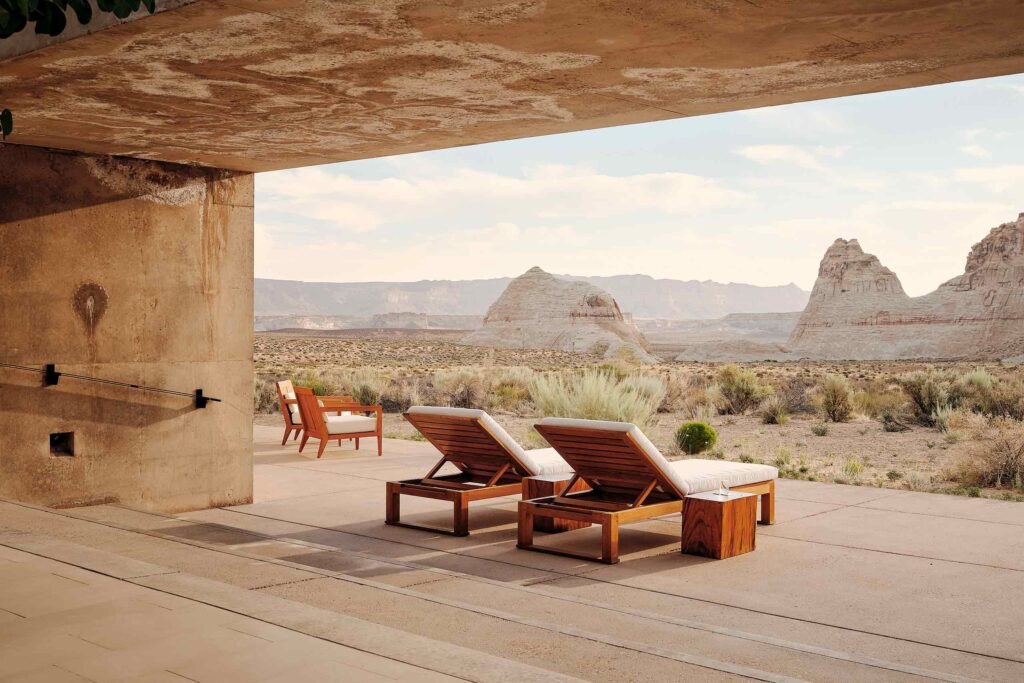 Loungers looking out towards rock formations at Amangiri, Lake Powell, Utah, USA