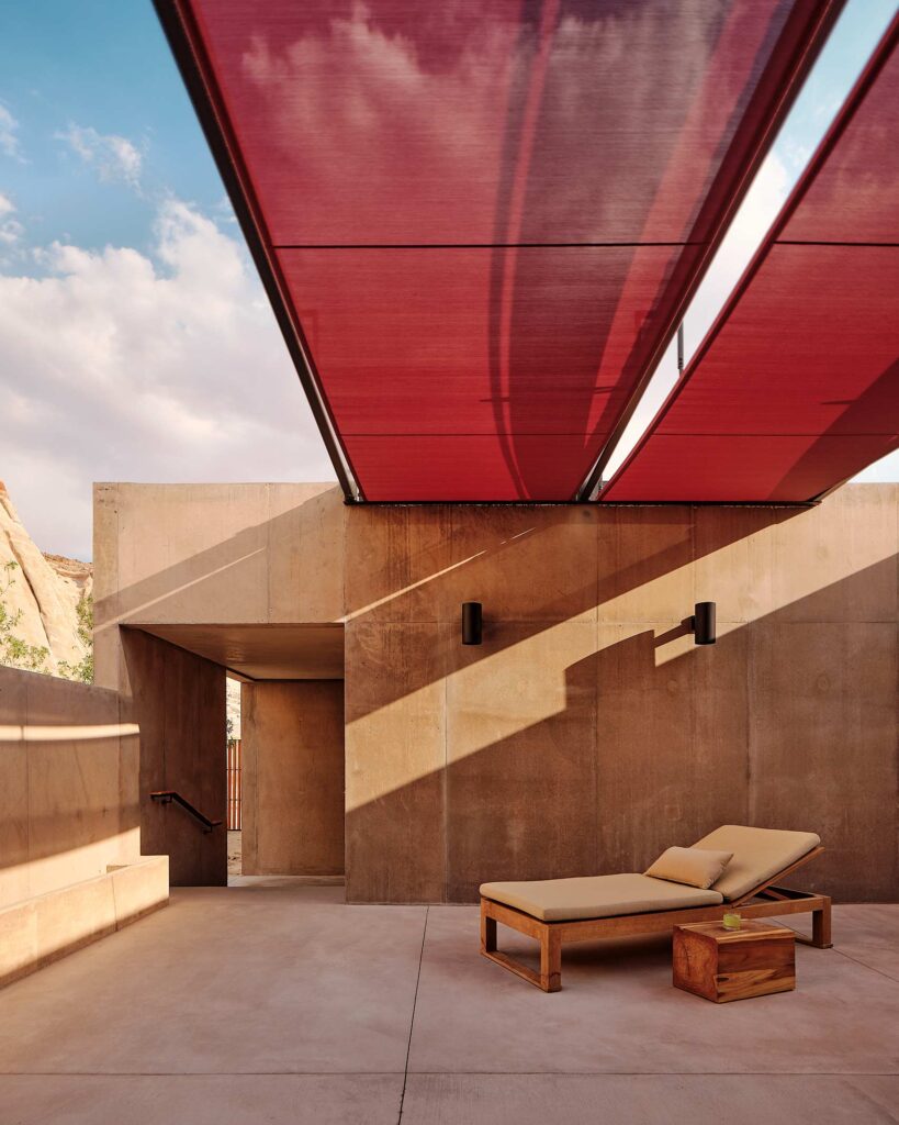 A lounger beneath a red canopy at Amangiri, Lake Powell, Utah, USA