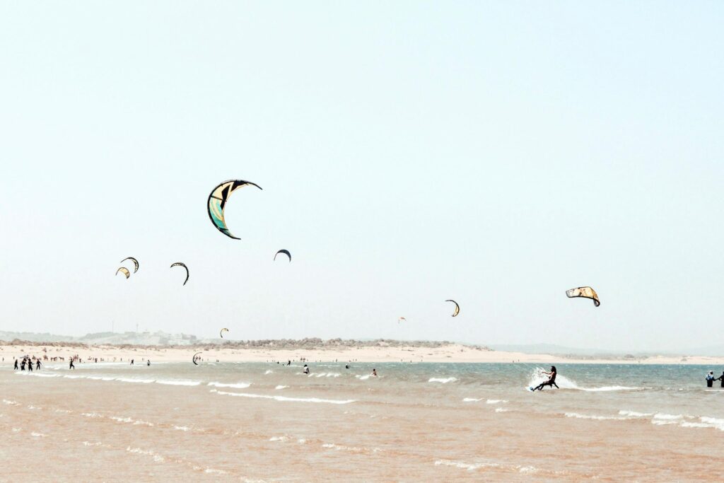 Kite surfers on the beach in Essaouira, Morocco, an example of Alternative winter escapes