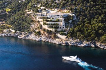 Ultima Collection x Burgess Yachts – A yacht sits on the waters outside of Ultima Corfu.